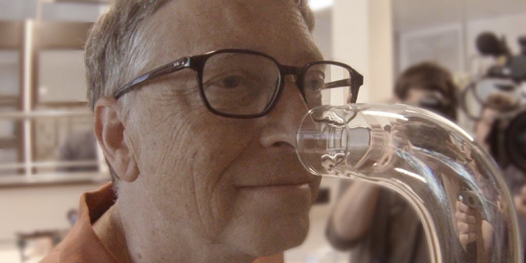Photo of Bill Gates sniffing a tube containing \